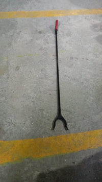 The pick up stick for elderly in a home setting, retrieving an item.