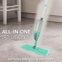 The spray mop standing upright next to a wall, showing its practical height.