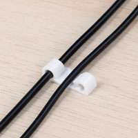 Multiple cable clips securing various power cords to maintain an organised workspace.