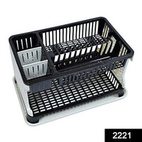 Multi-level kitchen dish rack organizing plates, cups, and cutlery.