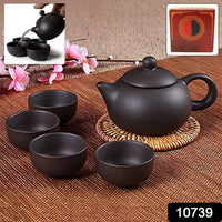 Matte black ceramic teapot alongside four matching ceramic cups