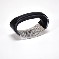The ergonomic grip handles of the Quickslice garlic crusher, designed for comfortable use.