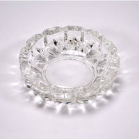 Stylish clear glass ashtray on a tabletop, enhancing home or office decor.