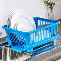 Plastic dish drainer rack with utensil holder in a brown box for kitchen organization.