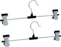 Organized wardrobe section showcasing clothes neatly hung on stainless steel hangers.