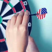 A person holding a steel tip dart, ready to throw at a dartboard.
