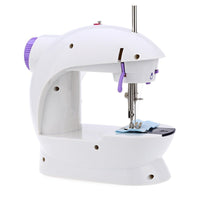 Close-up of the mini sewing machine's needle and thread for fabric stitching.