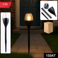 Solar garden light glowing warmly outdoors at night