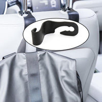 Compact car back support hanger securely attached to a car seat.