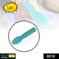 Close-up of the plastic foot scrubber, highlighting its dead skin remover surface.
