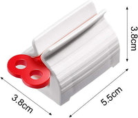 A hand turning the knob of the toothpaste squeezer to effortlessly dispense paste.