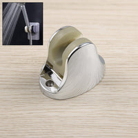 Adjustable hand shower holder with fixing screws in a modern bathroom.