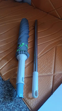 Self wringing mop's microfiber head close-up with cleaning debris trapped