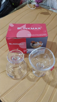 Pair of elegant glass dessert bowls displayed together on a table.