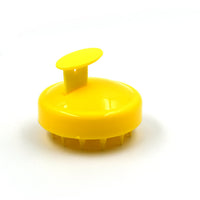 Scalp massager brush showing its compact and travel-friendly design.