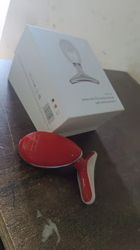 Compact electric face massager with its charging cable