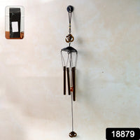 Close-up of metal wind chime with Om symbol showing tuned metal tubes