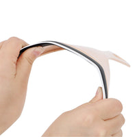 Two hands gently bend the flexible beige car mirror wiper, highlighting its pliable material.