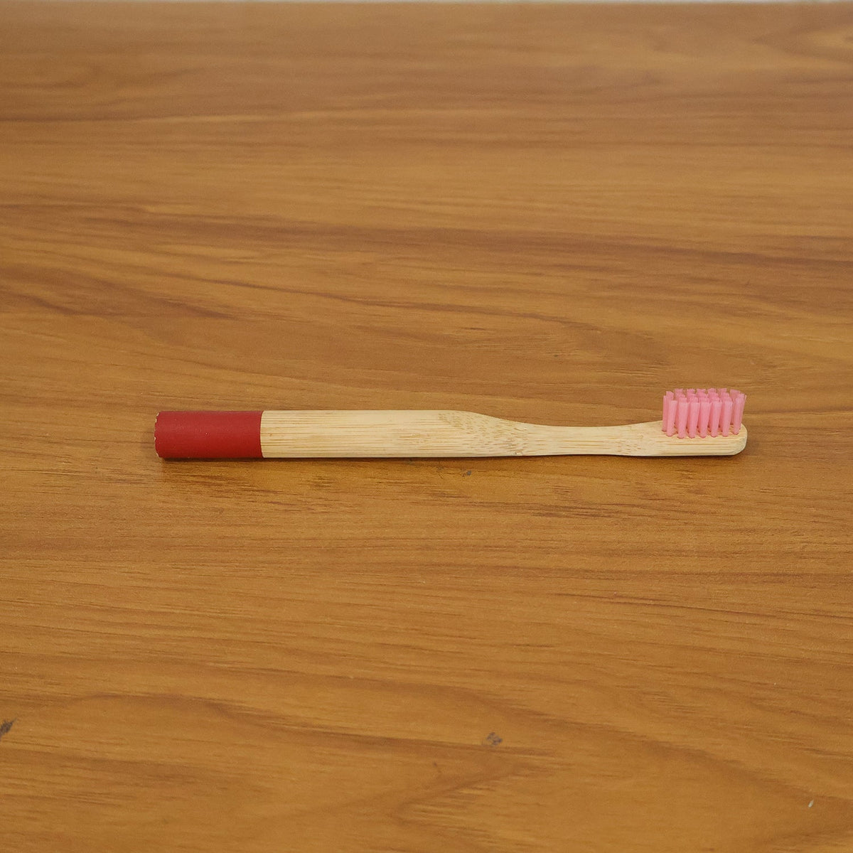 Lifestyle image of bamboo toothbrush in bathroom setting
