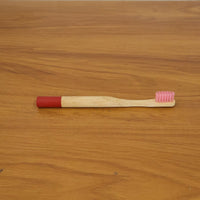 Lifestyle image of bamboo toothbrush in bathroom setting
