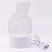 Teddy bear LED Night Lamp glowing softly in dark room
