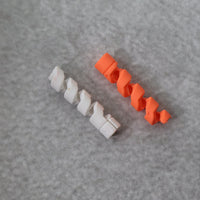 Flexible spiral cable protector in an uncoiled state, ready for installation.