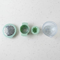 Top-down view showing various grating surfaces on manual vegetable grater