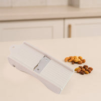 Dry fruit slicer showing slicing action on cashews and ginger