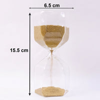 Smooth yellow sand flowing inside an elegant glass hourglass timer.