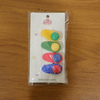 Snap hair clip attached to hair showing decorative rounded design
