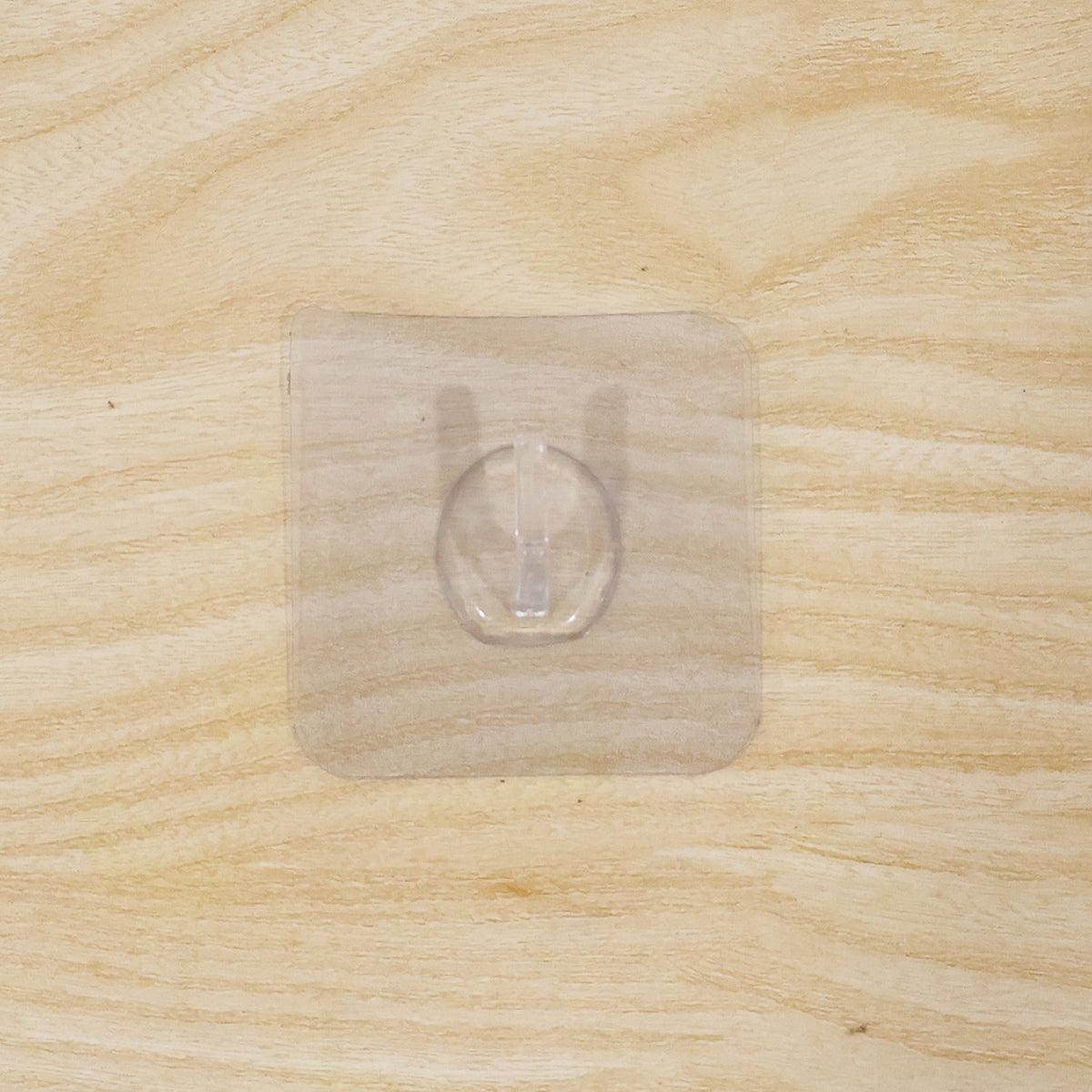 Wall hook on wooden door with transparent adhesive