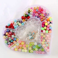 Detail of heart-shaped plastic bead storage box showing bow design lid