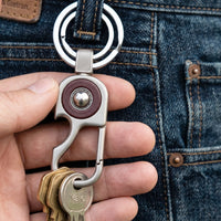 Portable metal key holder with dual rings for organizing multiple keys.