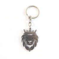 Angled view of metal lion head keychain highlighting textured craftsmanship