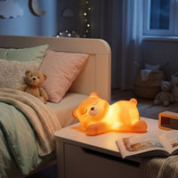 Adorable sleeping bear LED night light creating a cosy ambiance on a table.