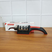 An Indian user demonstrates the manual knife sharpener on a steel blade.