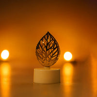 Golden leaf LED candles illuminating a festive setting, creating a serene ambience.
