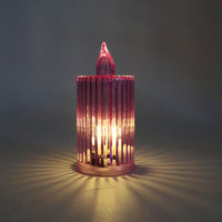 Warm yellow flickering LED candle set with ribbed surface