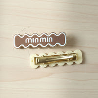 Detailed close-up of secure snap mechanism on wavy hair clip