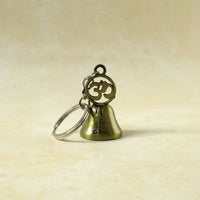 Om temple bell keychain used as decorative bag charm accessory