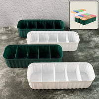 Four 5-compartment drawer organizers neatly stacked, storing socks and underwear.