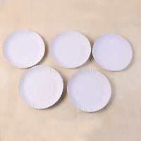 9 inch compostable paper plates arranged for party service