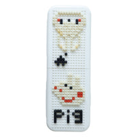 Decorative pen holder with pixel art design on an organized desk