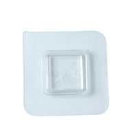 Transparent no-drill wall hook demonstrating versatile use in a home setting.