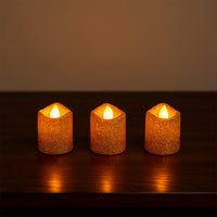 Safe flameless LED tealight candles with glitter finish on shelf