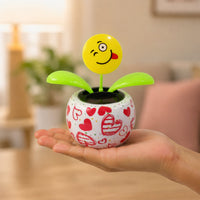 Solar activated bobbing flower toy for dashboard and shelves