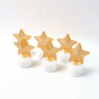 Top-down view showing a glowing LED star candle with flickering light