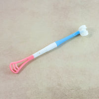 Baby tongue cleaner showing soft brush and scraper ends for oral care