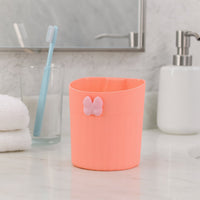 Adhesive-backed toothbrush holder mounted on bathroom wall displaying no-drill installation