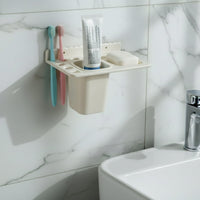Soap tray with drainage holes in the wall mounted toothbrush holder keeping soap dry.